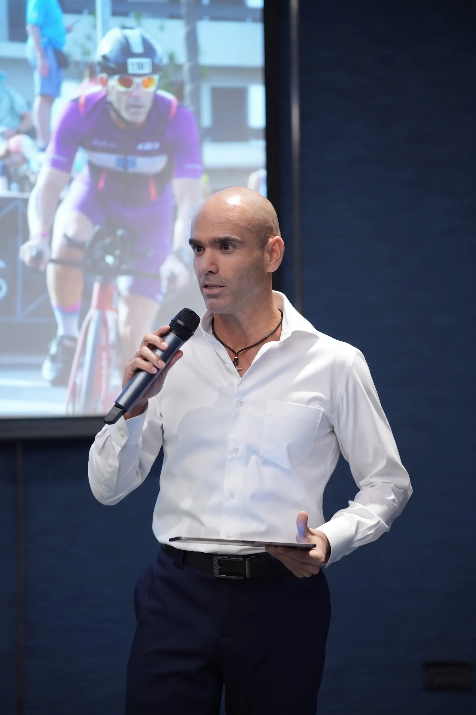 Coach Raz delivering a corporate lecture on stage